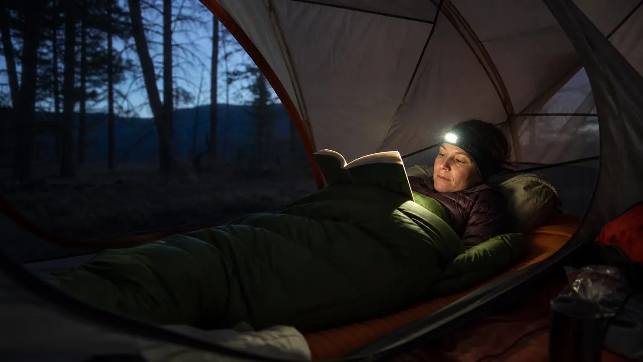oaskys sleeping bag unrolled on a sleeping pad inside a tent, morning light coming through the rain fly